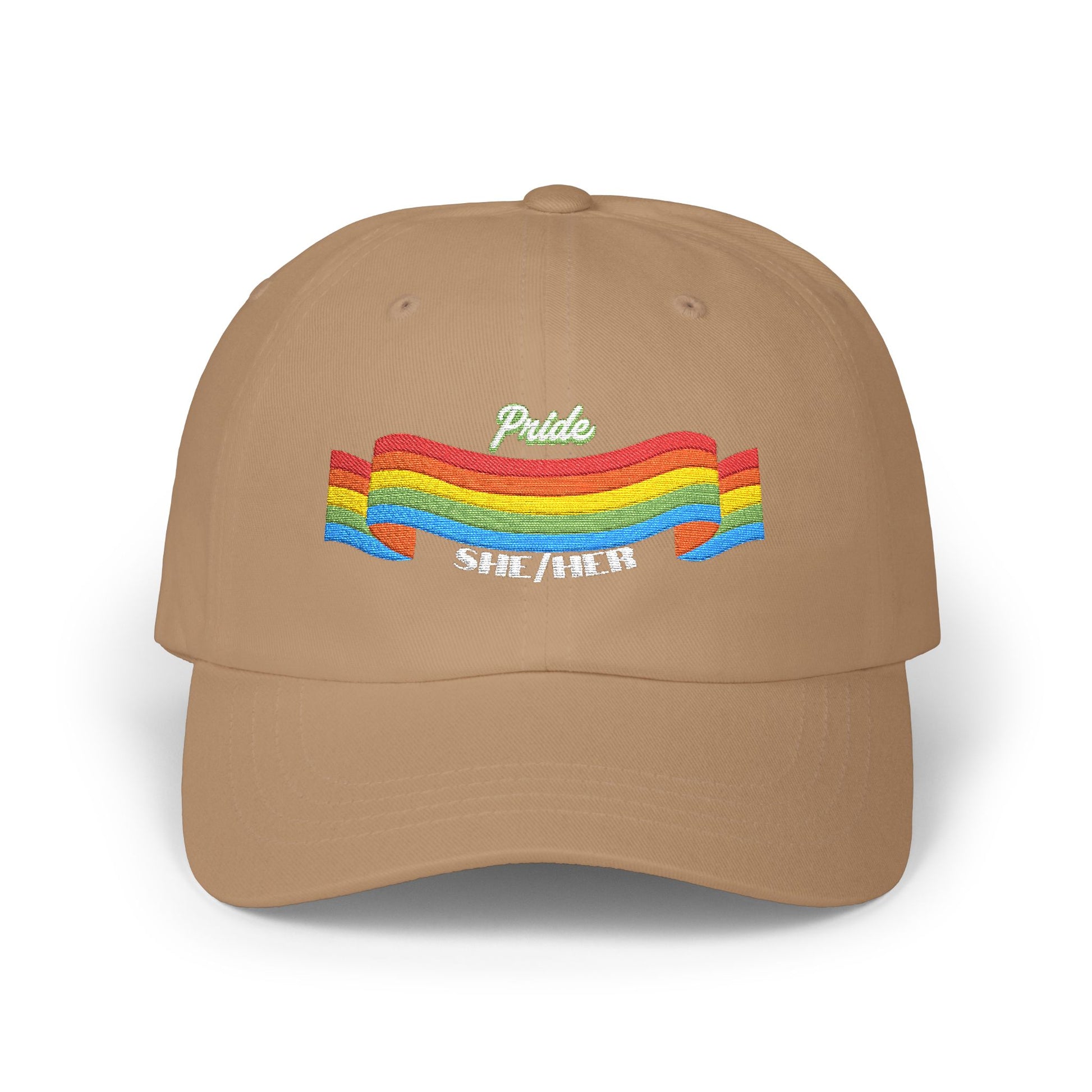 A khaki cap from the Worldwide PRIDE store, featuring a rainbow design and the embroidered pronouns she/her.