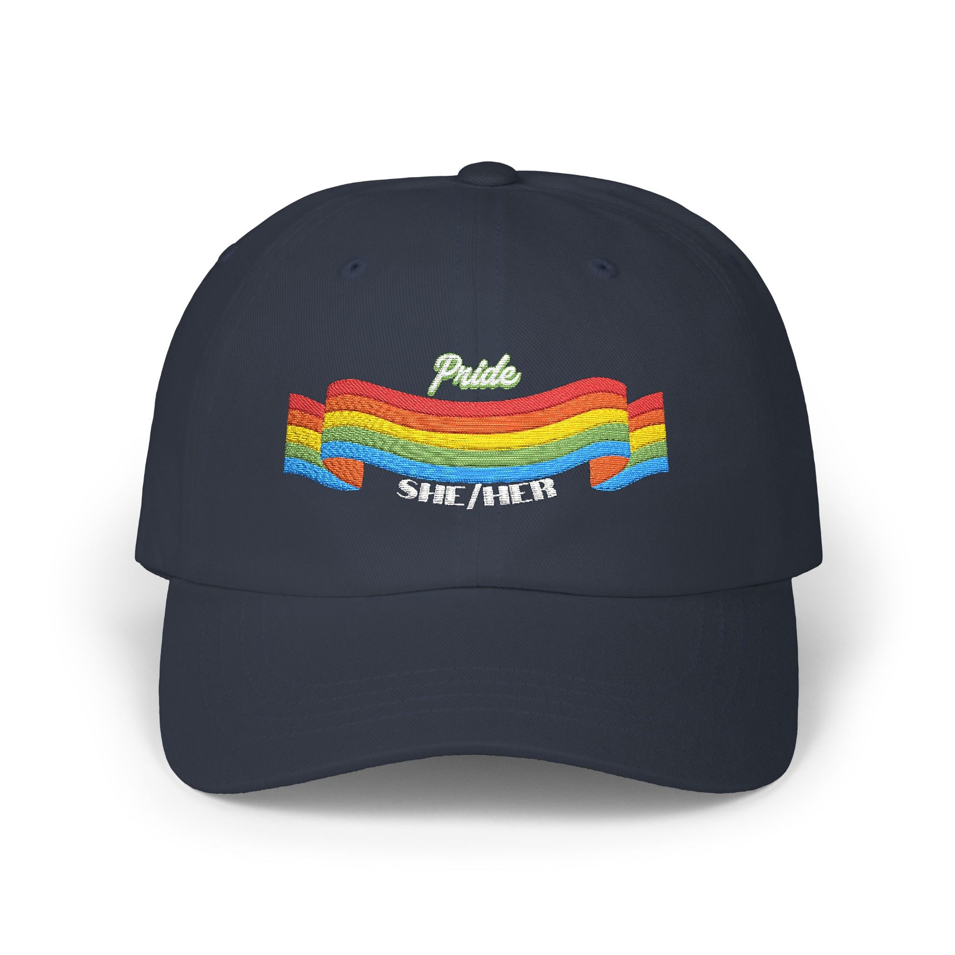 A navy blue cap from the Worldwide PRIDE store, featuring a rainbow design and the embroidered pronouns she/her.