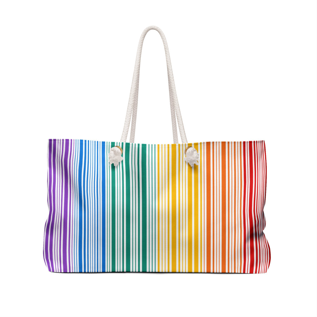 A weekender bag with rainbow stripes that celebrates PRIDE. The bag, a tribute to the LGBTQ community, features white rope handles that stand out against a pristine white background.