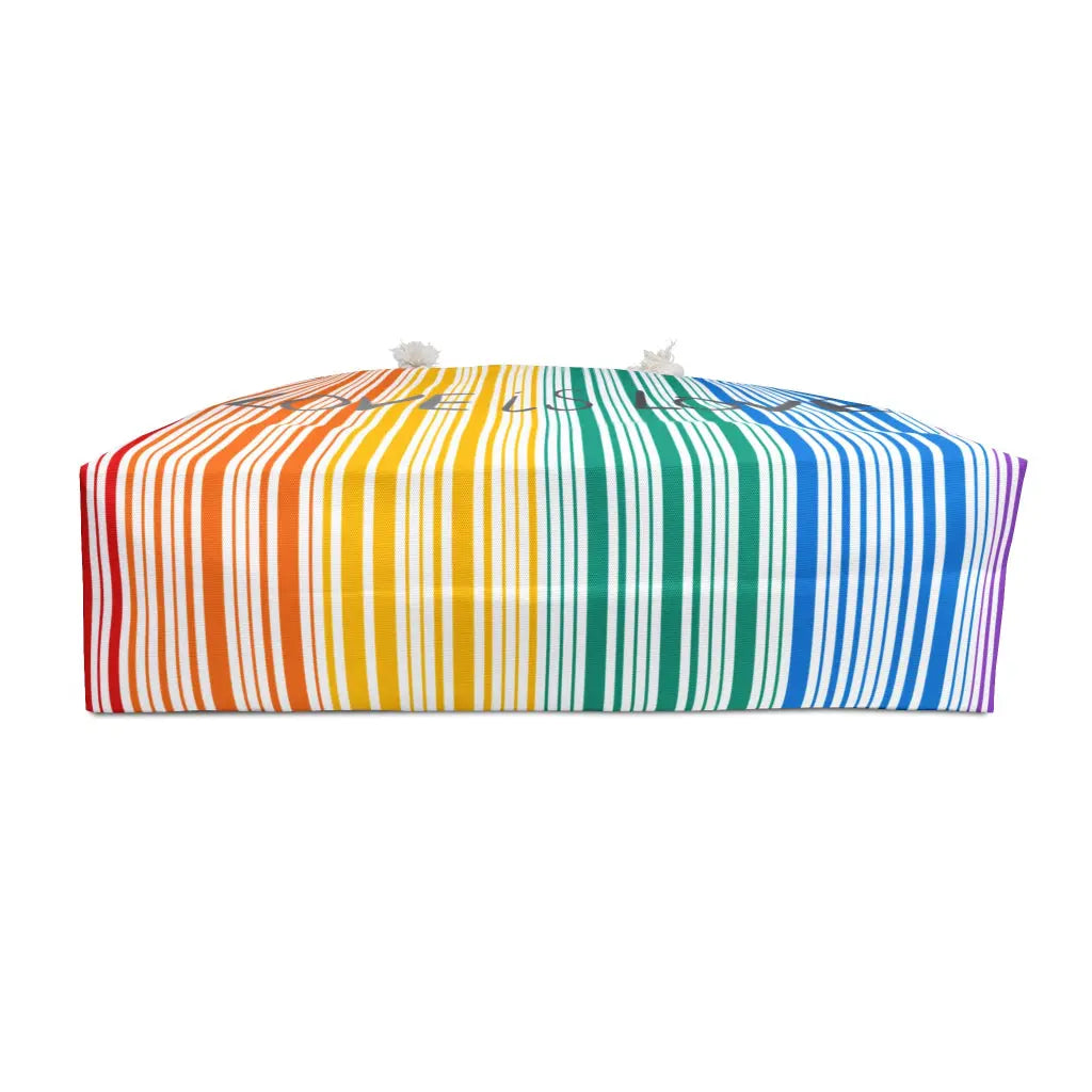 A photo of the bottom of a weekender bag with rainbow stripes that celebrates PRIDE. The bag, a tribute to the LGBTQ community, features white rope handles that stand out against a pristine white background.