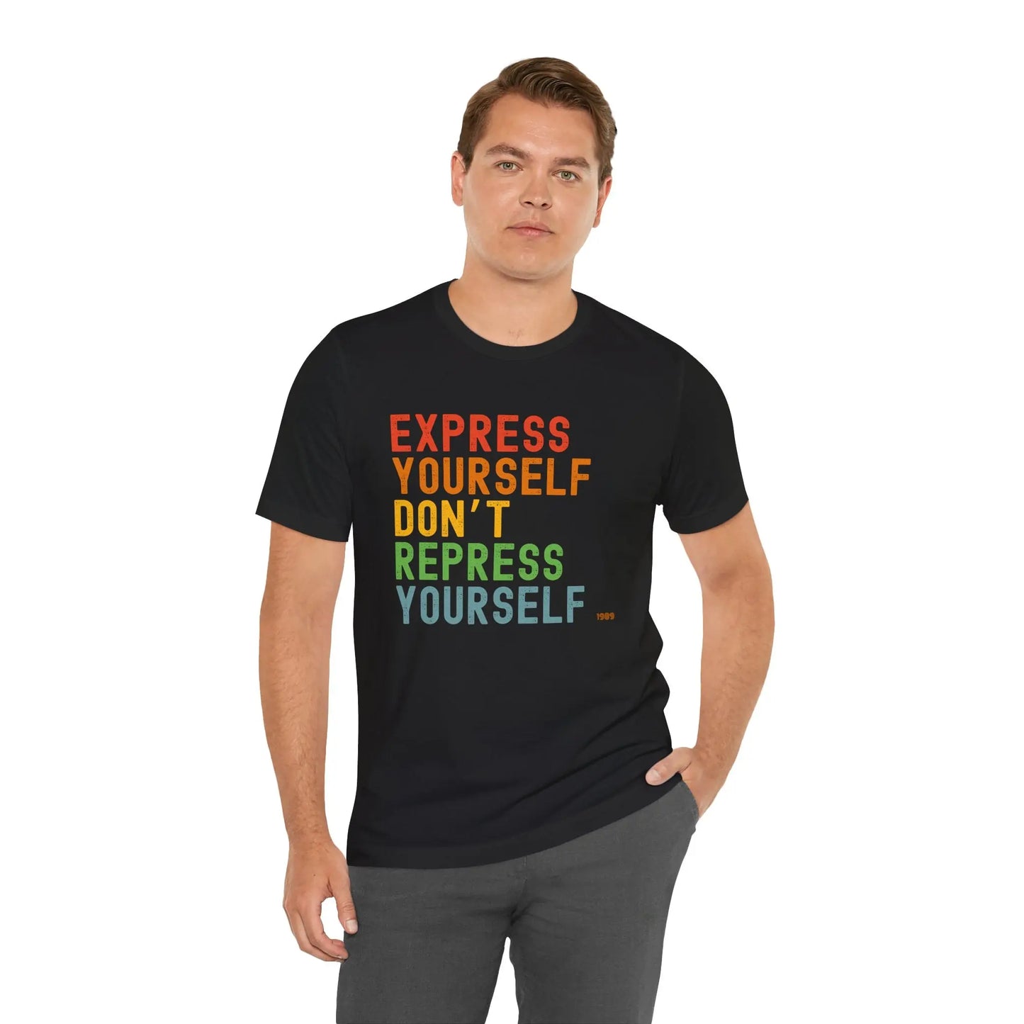 A person wearing a black unisex t-shirt with the text 'EXPRESS YOURSELF DON'T REPRESS YOURSELF' in multicolored letters on the front.