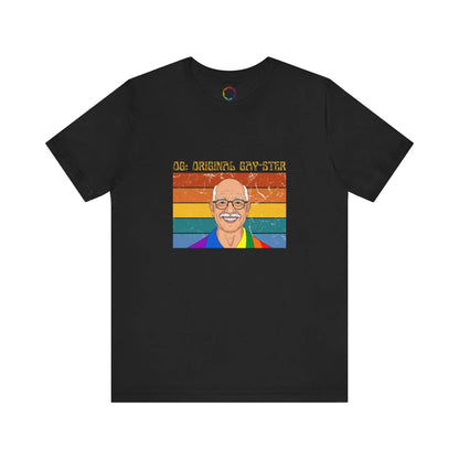 A black unisex short-sleeve t-shirt with a graphic print of a person's face and the text 'ORIGINAL GAY-STER' in rainbow-colored letters.