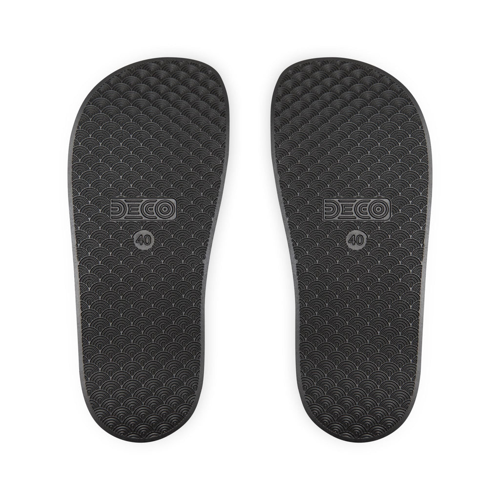 The soles of the black rainbow PRIDE slides.
