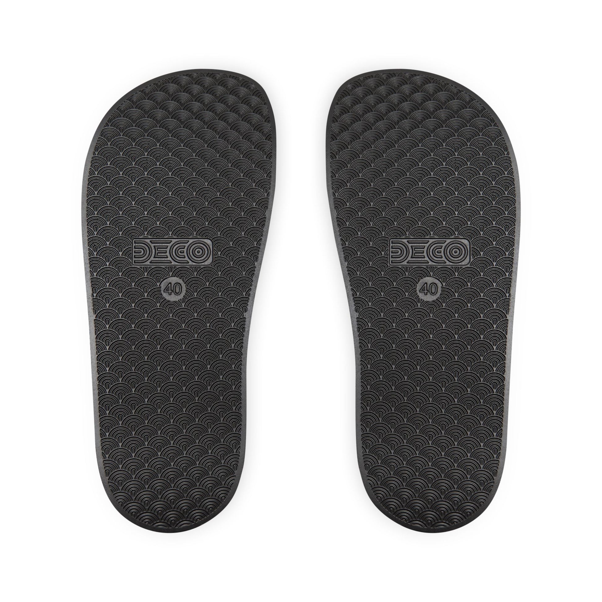 The soles of the black rainbow PRIDE slides.