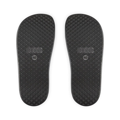 The soles of the black rainbow PRIDE slides.