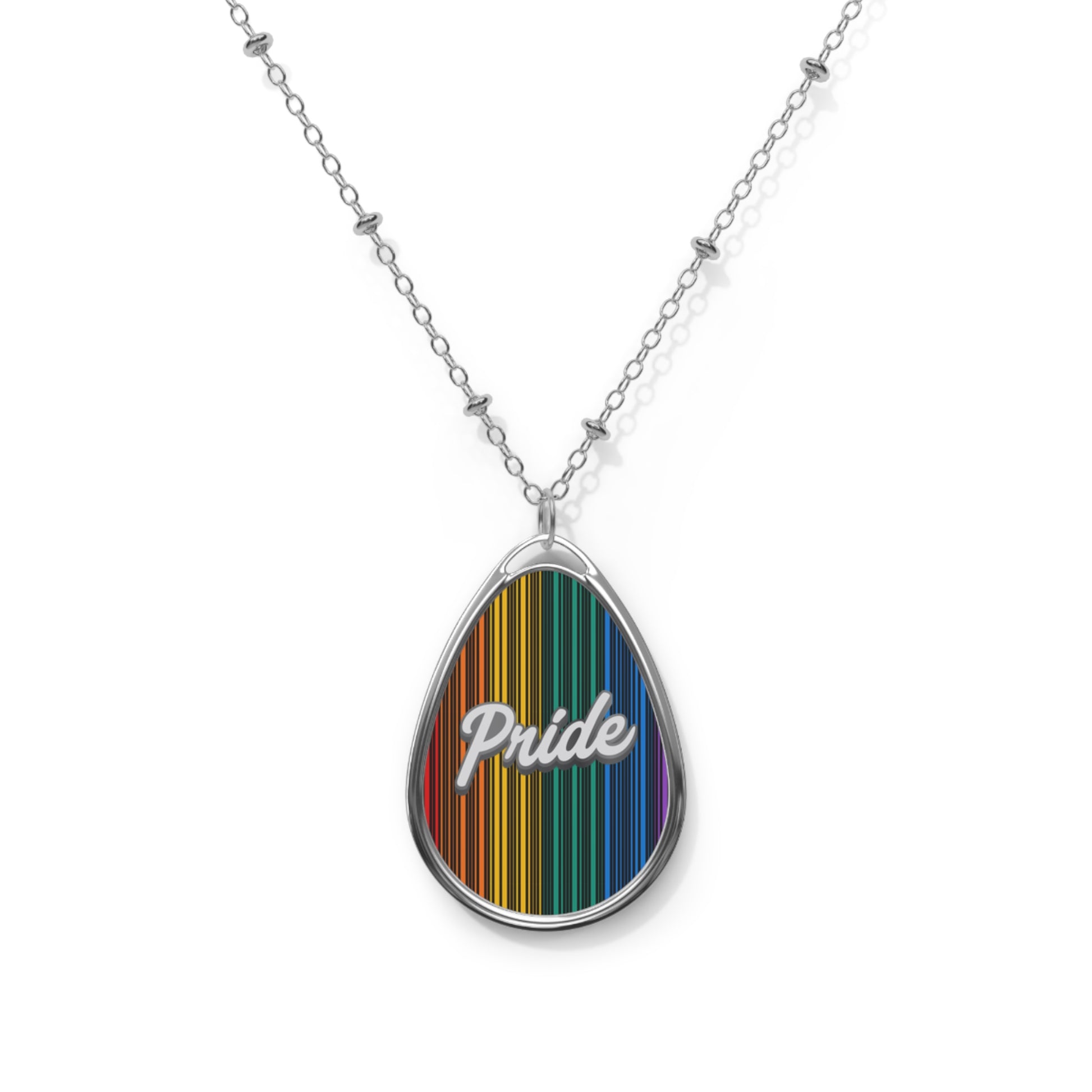 A close up of a silver chain necklace showcases a teardrop-shaped pendant adorned with a rainbow-striped pattern and the word PRIDE in elegant white cursive. The close-up captures the vibrant colors and shiny metal beautifully.