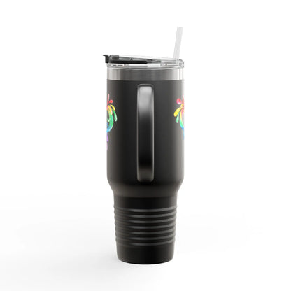A white travel mug with a handle and a straw, showcasing a colorful heart made of water splashes. The Worldwide PRIDE cup is celebrating diversity and love.