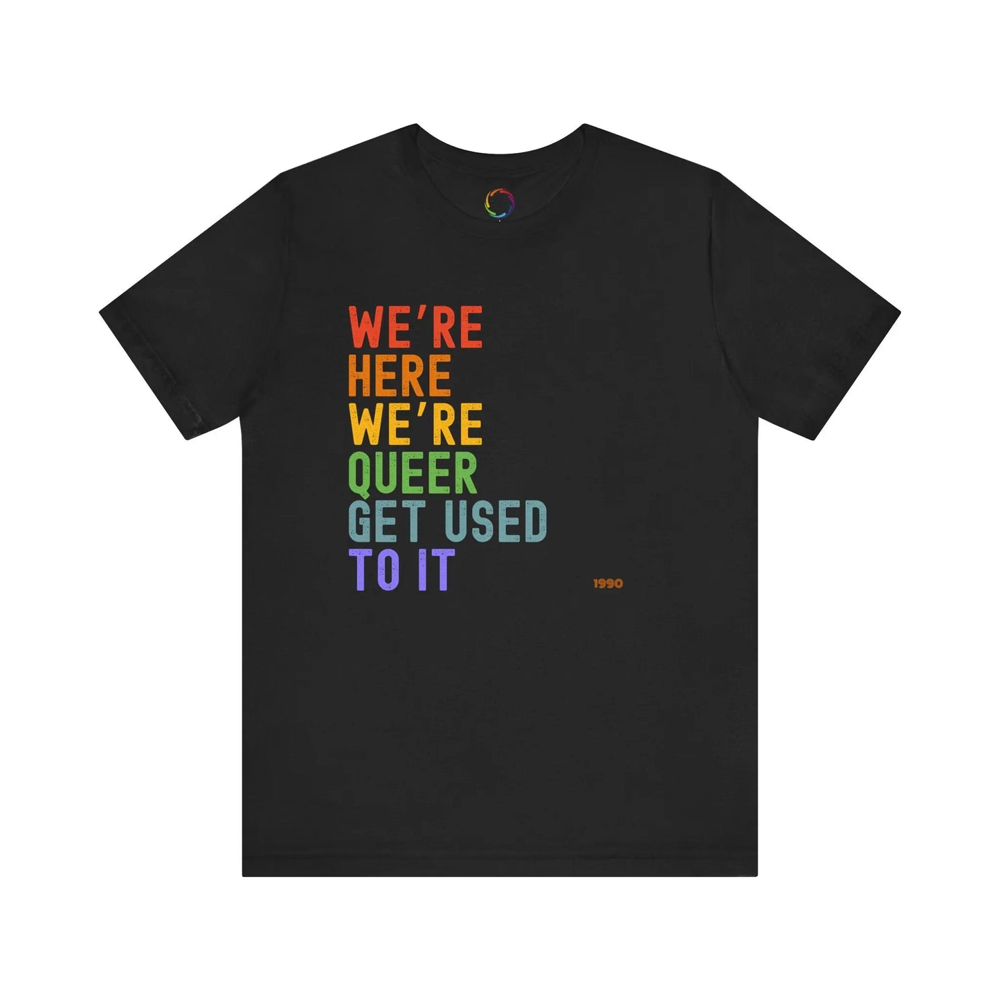 A black unisex crew neck t-shirt with the text 'WE'RE HERE WE'RE QUEER GET USED TO IT' printed in multicolored letters.