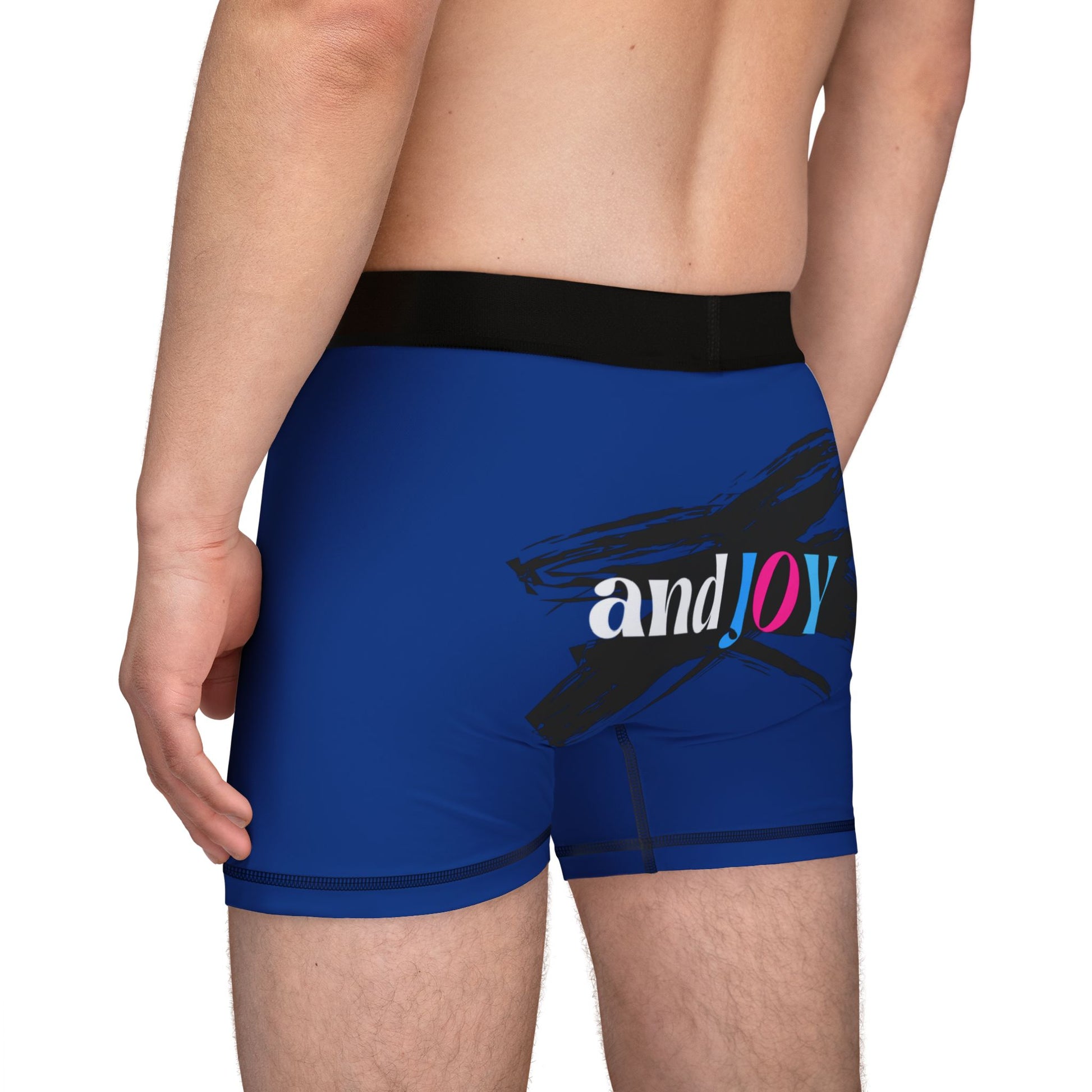 A person wearing blue boxer briefs with a black waistband, proudly showcasing My PRIDE in colorful letters on the front and and JOY on the back. This vibrant design celebrates the worldwide PRIDE and spirit of the LGBTQ community.