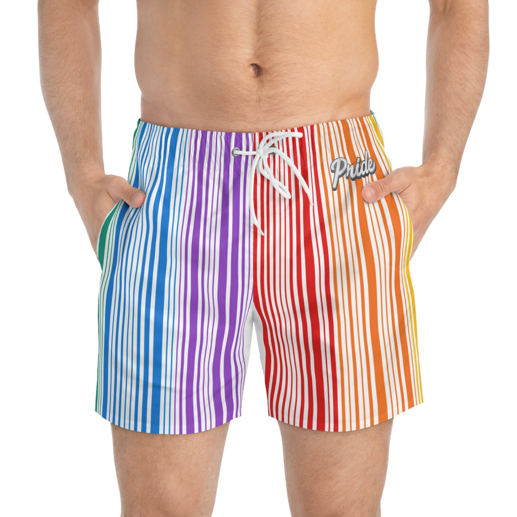 Someone wearing the PRIDE Rainbow Swim Trunks with hands in pockets. The quick-drying polyester boasts vibrant vertical stripes in blue, green, purple, red, orange, yellow. Pride is printed near the waistband.