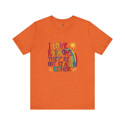An orange unisex short-sleeve t-shirt with a colorful graphic that includes text saying "I love rainbows they're not straight either."