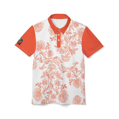 An orange and white paisley flower polo shirt from the Worldwide PRIDE Subtlety collection. On the right sleeve is a small colorful lion, an homage to the LBGTQ community. The person is placed against a plain white backdrop.
