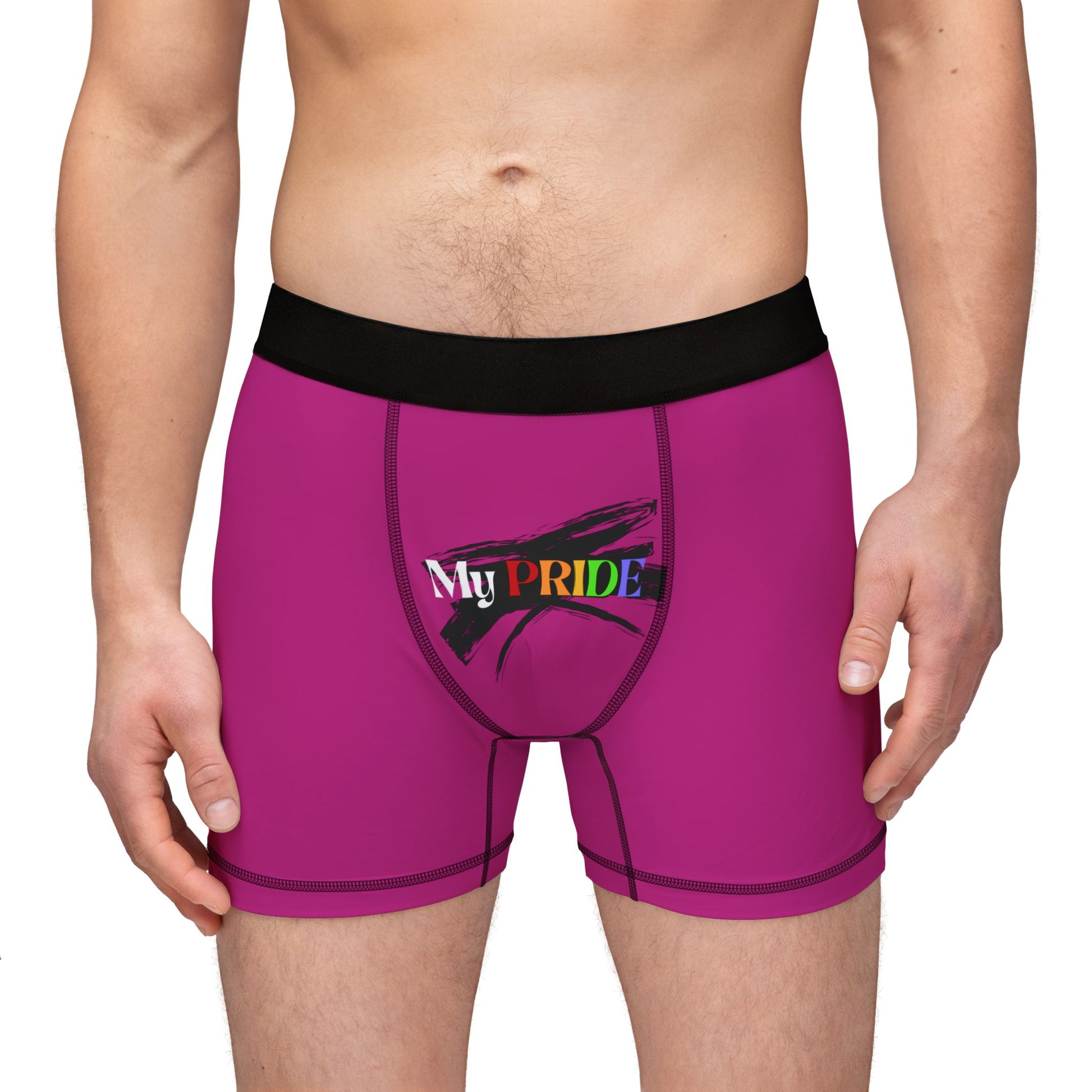 A person wearing pink boxer briefs with a black waistband, proudly showcasing My PRIDE in colorful letters on the front and and JOY on the back. This vibrant design celebrates the worldwide PRIDE and spirit of the LGBTQ community.