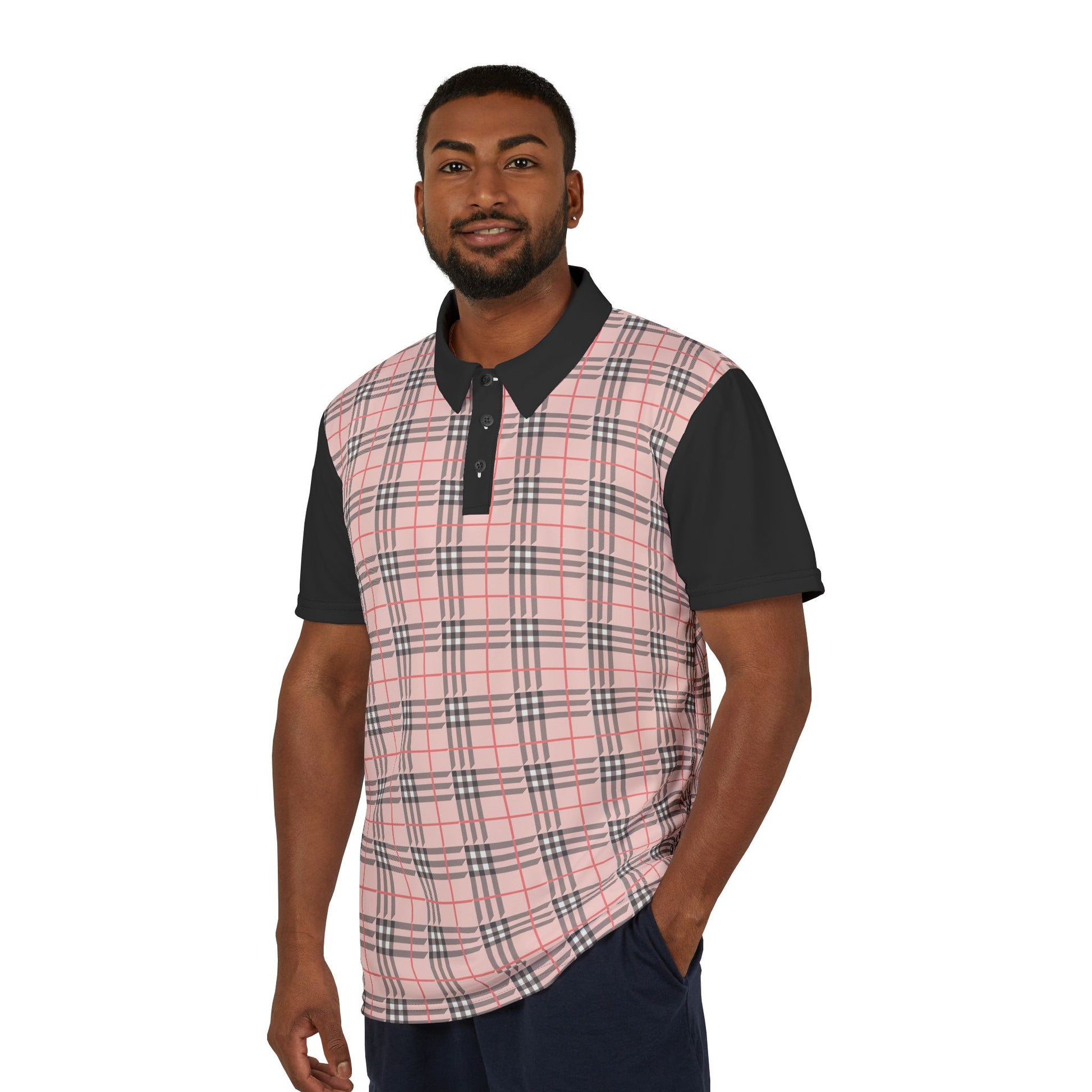 A person wearing a polo shirt showcasing a pink "prideberry" plaid pattern on the front with solid black short sleeves. The shirt also features a collar and a small, colorful lion on the right sleeve, celebrating the LGBTQ community's vibrant spirit.