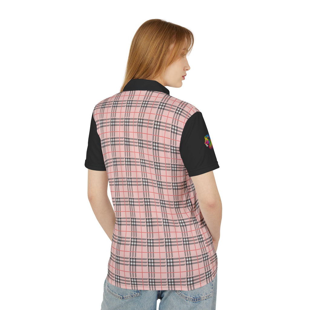 A person wearing a polo shirt showcasing a pink "prideberry" plaid pattern on the front with solid black short sleeves. The shirt also features a collar and a small, colorful lion on the right sleeve, celebrating the LGBTQ community's vibrant spirit.