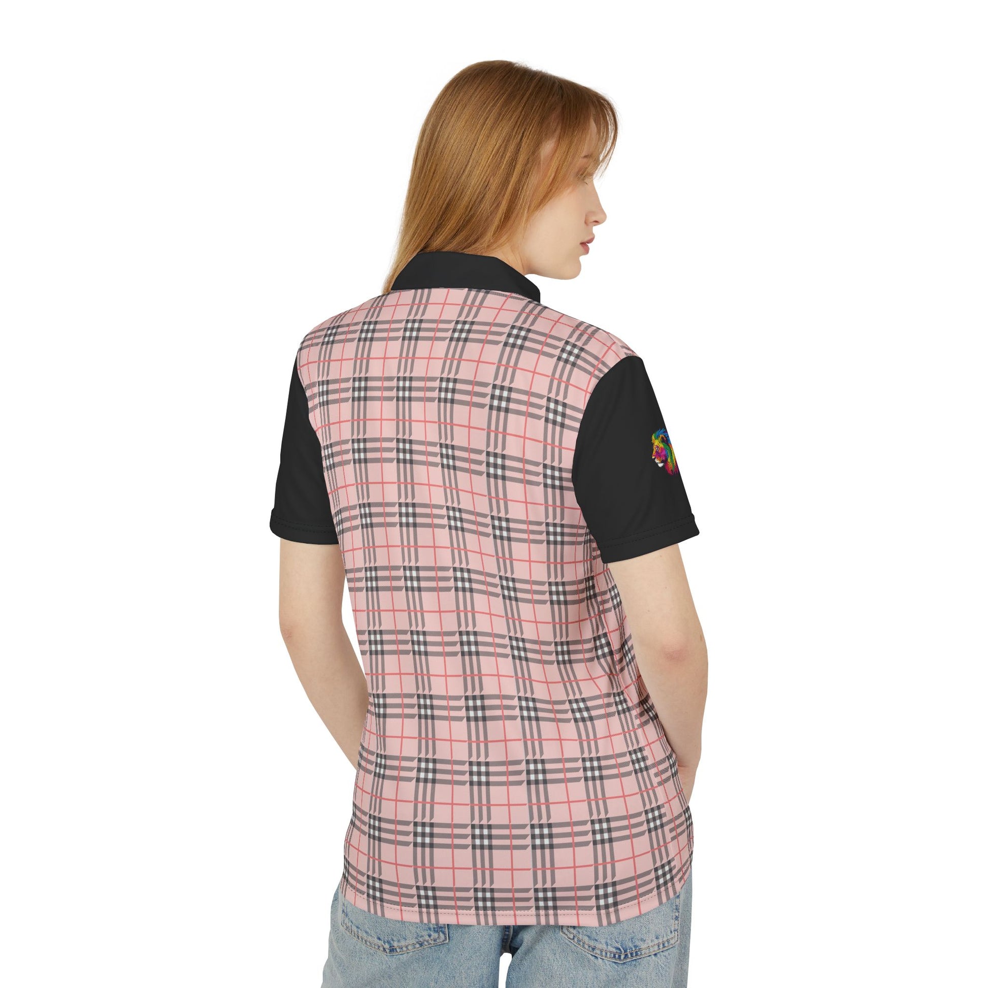 A person wearing a polo shirt showcasing a pink "prideberry" plaid pattern on the front with solid black short sleeves. The shirt also features a collar and a small, colorful lion on the right sleeve, celebrating the LGBTQ community's vibrant spirit.