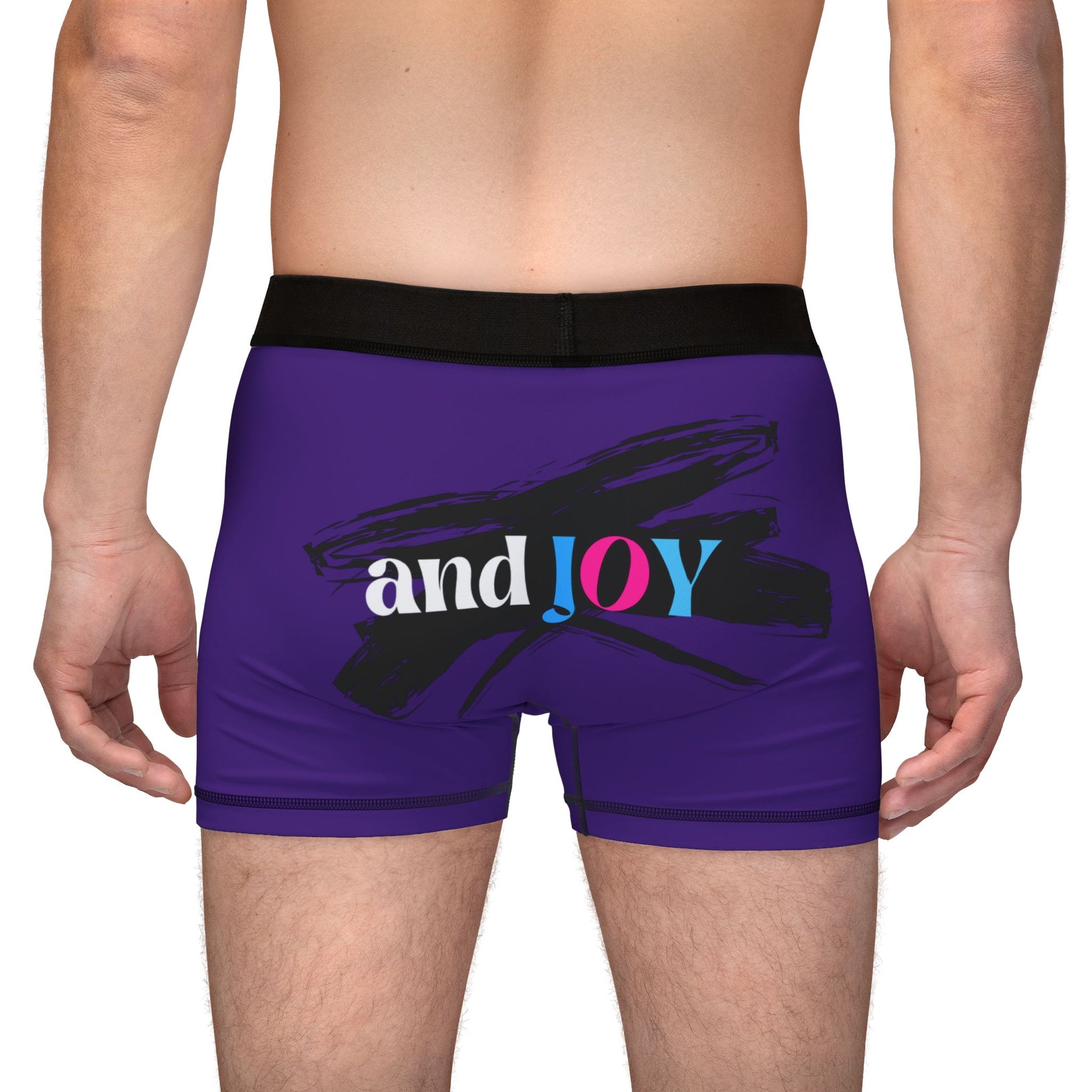 A person wearing purple boxer briefs with a black waistband, proudly showcasing My PRIDE in colorful letters on the front and and JOY on the back. This vibrant design celebrates the worldwide PRIDE and spirit of the LGBTQ community.