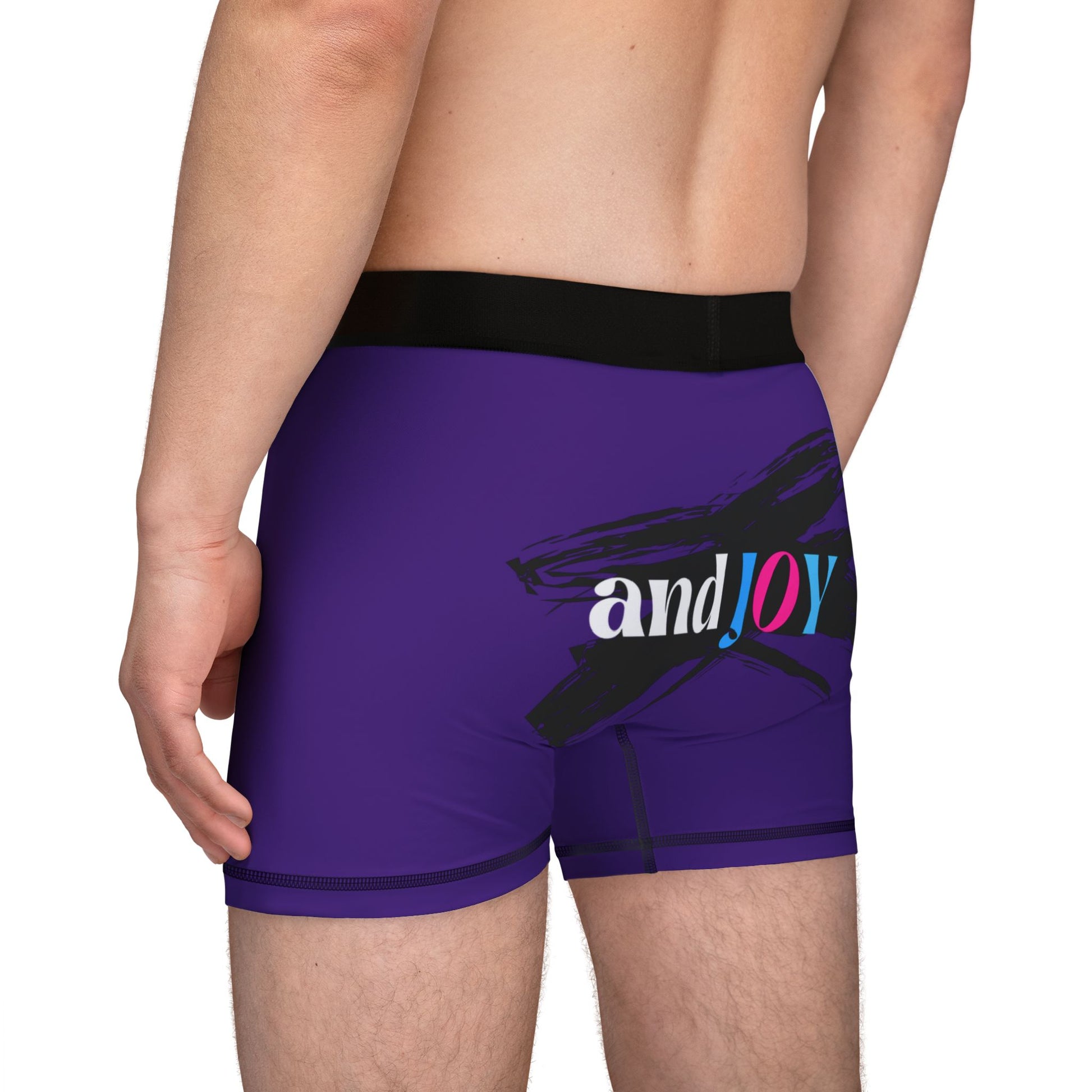 A person wearing purple boxer briefs with a black waistband, proudly showcasing My PRIDE in colorful letters on the front and and JOY on the back. This vibrant design celebrates the worldwide PRIDE and spirit of the LGBTQ community.