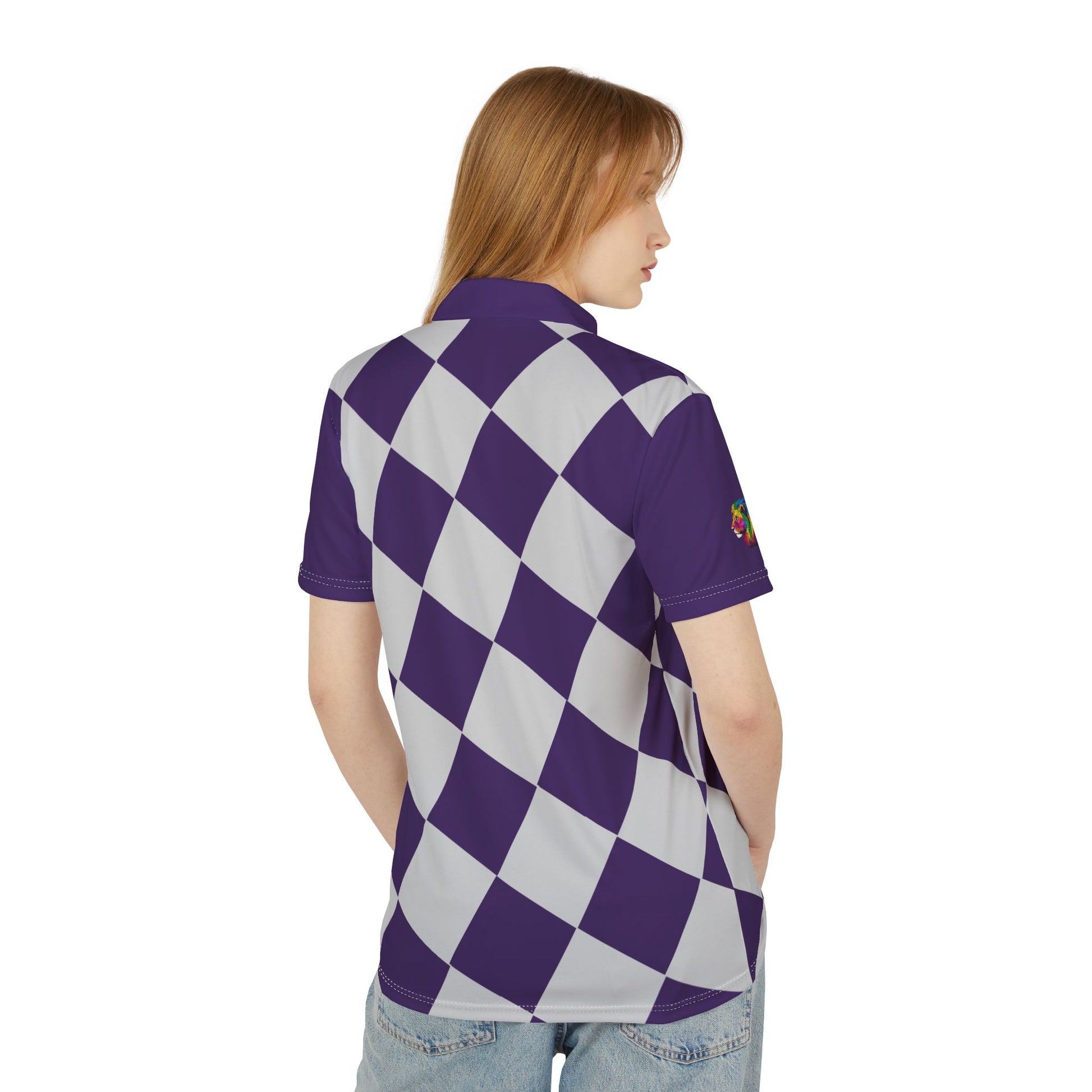 A person wears a purple and white checkered polo shirt from the Worldwide PRIDE Subtlety collection. On the right sleeve is a small colorful lion, an homage to the LBGTQ community. The person is placed against a plain white backdrop.