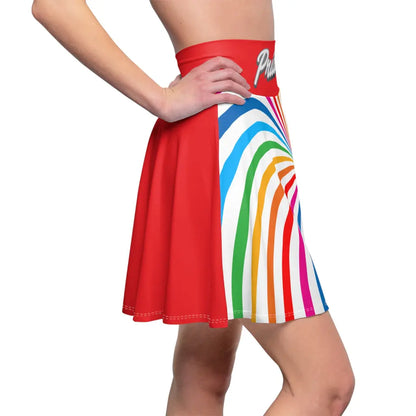 A person is wearing a colorful skirt with a spiral of rainbow stripes converging at the center, celebrating worldwide PRIDE. The red waistband features Pride written in white script, representing the LGBTQ community, as their hand rests elegantly on the side.