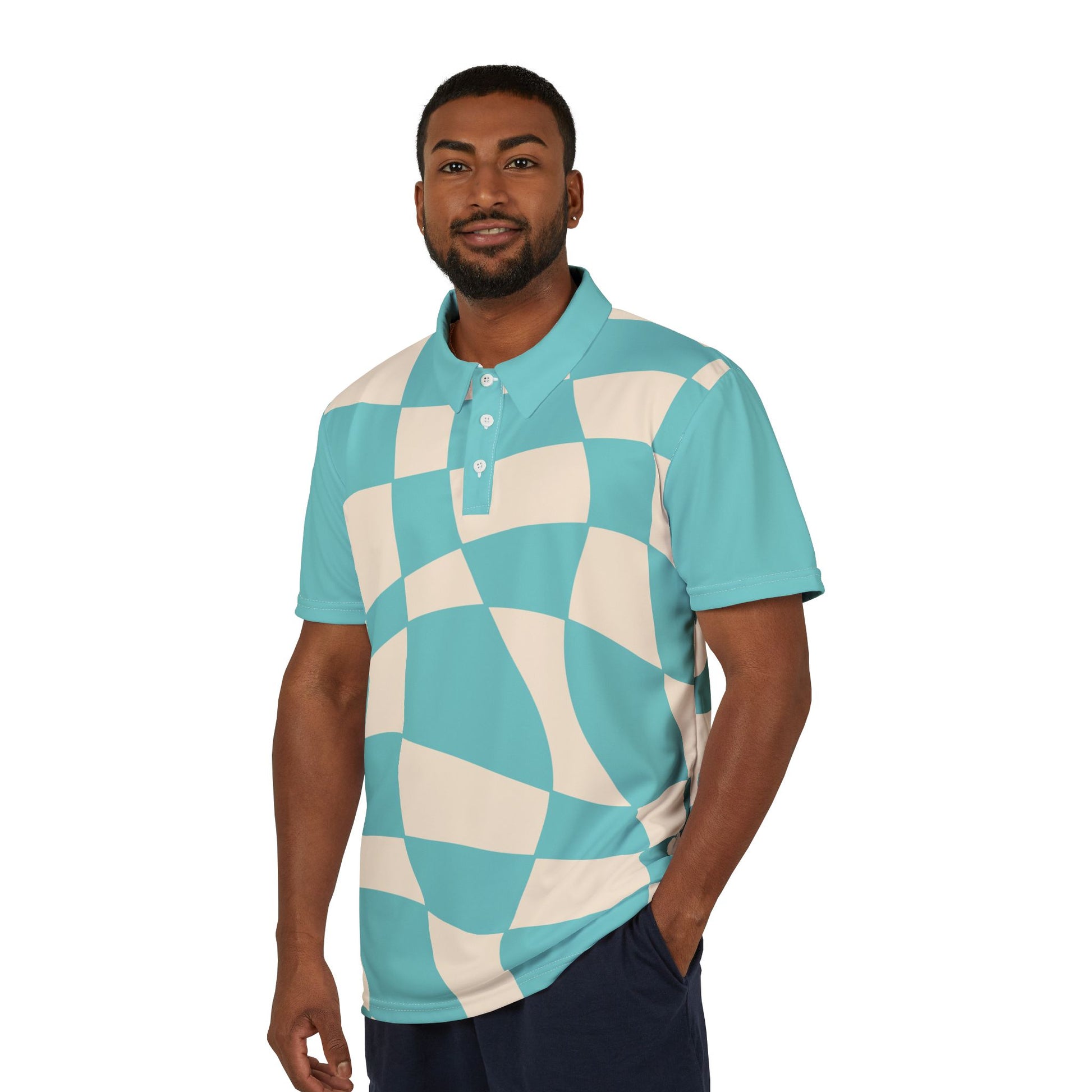 A person wears a polo shirt, part of the Subtlety collection, showcases a teal and cream checkered pattern. It features a colorful lion on the right sleeve and a button-up collar, embodying Worldwide PRIDE with its vibrant design.