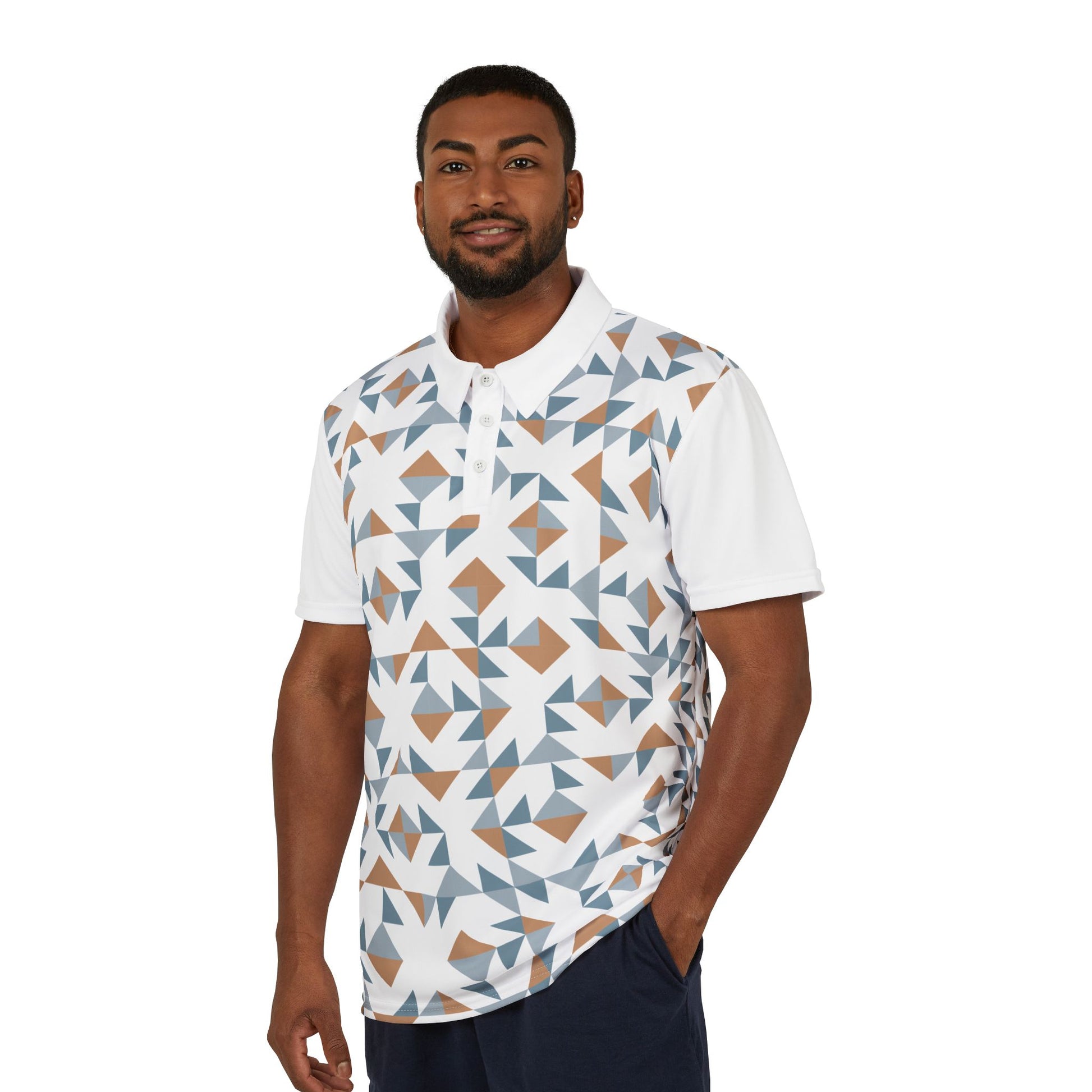 A person wears a white polo shirt boasts a geometric pattern with blue, brown, and white shapes. It features a collar, buttons, and a colorful lion on the left sleeve that embodies the spirit of Worldwide PRIDE. It is part of WWP's Subtlety collection.