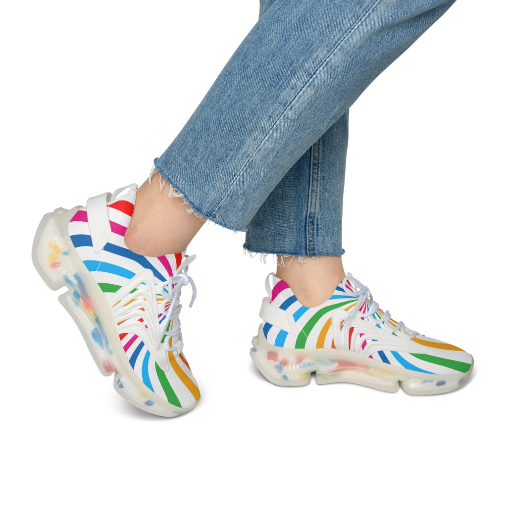 A person wearing colorful striped sneakers paired with light blue, frayed hem jeans celebrates Worldwide PRIDE. The vibrant sneakers with translucent soles echo the spirit of the LGBTQ community against a plain white background.