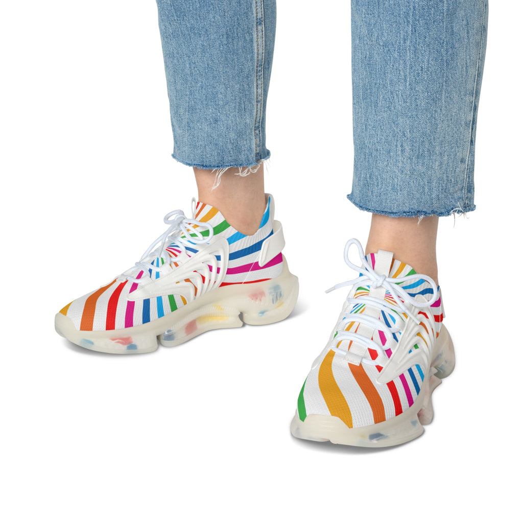 A person wearing colorful striped sneakers paired with light blue, frayed hem jeans celebrates Worldwide PRIDE. The vibrant sneakers with translucent soles echo the spirit of the LGBTQ community against a plain white background.