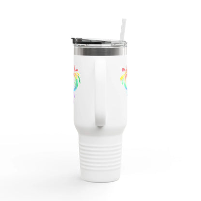 A white travel mug with a handle and straw, showcasing a colorful heart made of water splashes. The Worldwide PRIDE cup is celebrating diversity and love.