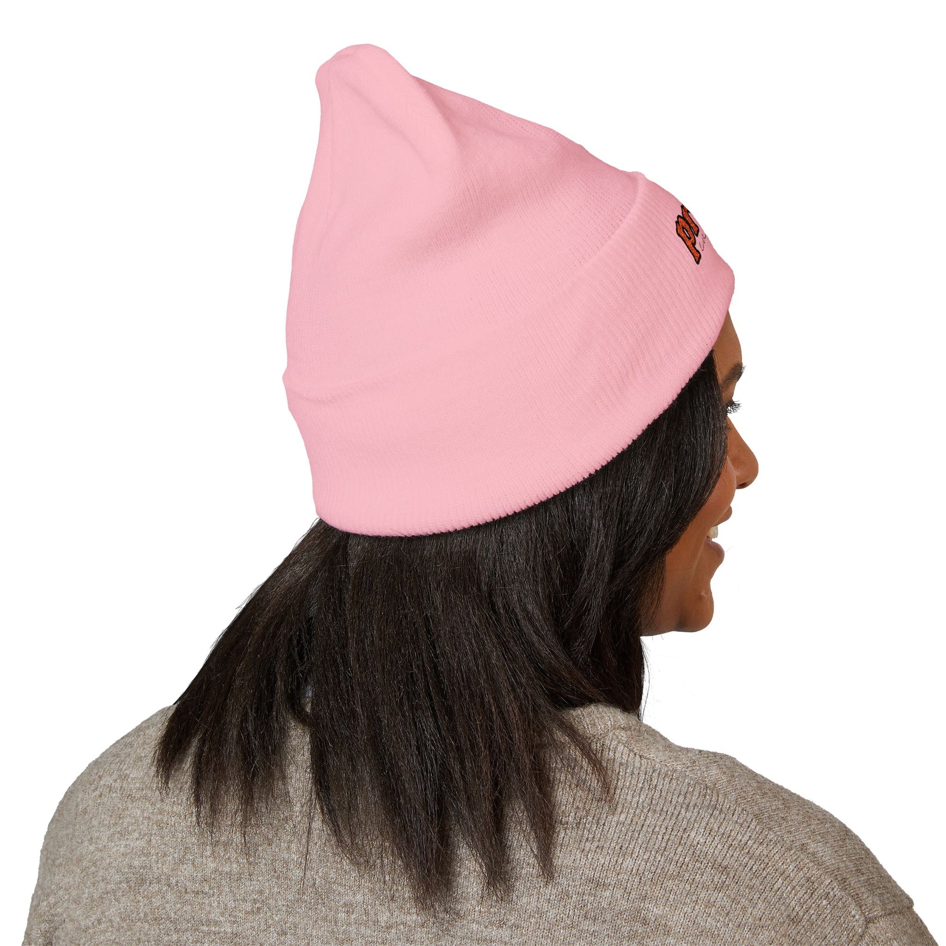 Back view of a person wearing a light pink beanie with “proud everyday" embroidered in rainbow colors and a heather brown sweater, looking slightly to the side with a neutral expression. Perfect for the LGBTQ community from the Worldwide PRIDE store.