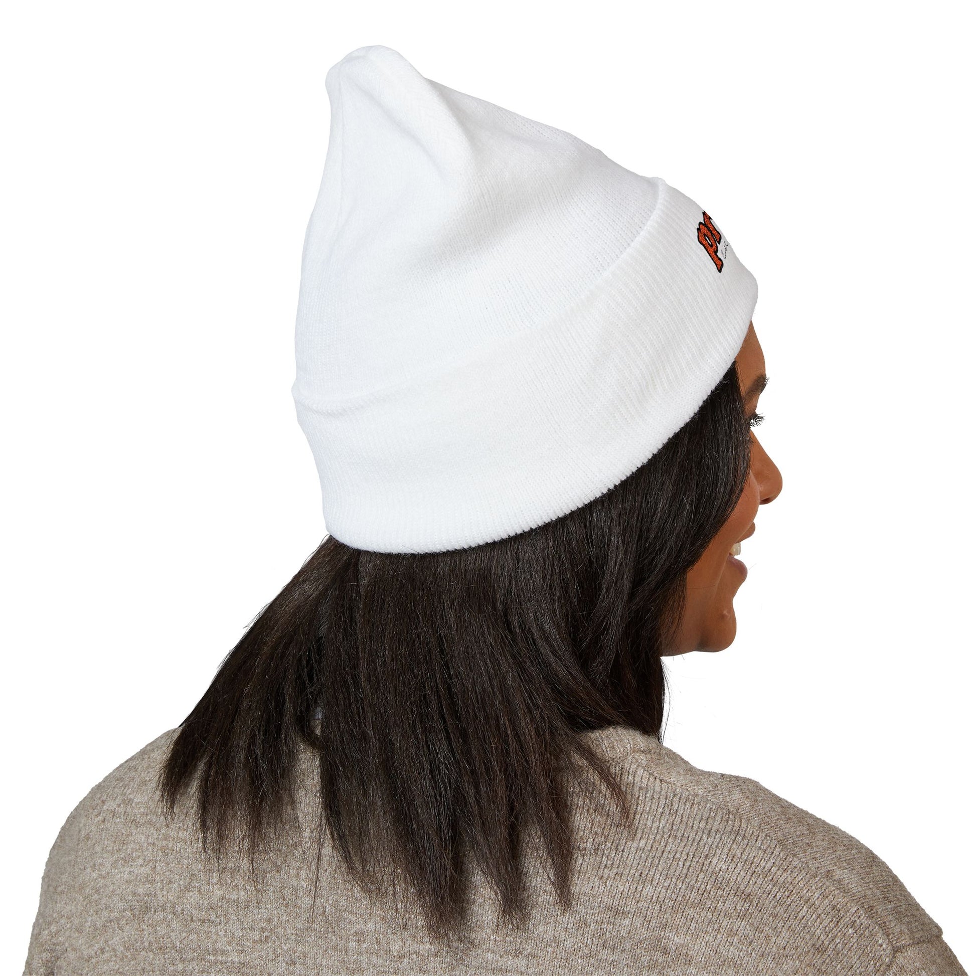 Back view of a person wearing a white beanie with “proud everyday" embroidered in rainbow colors and a heather brown sweater, looking slightly to the side with a neutral expression. Perfect for the LGBTQ community from the Worldwide PRIDE store.