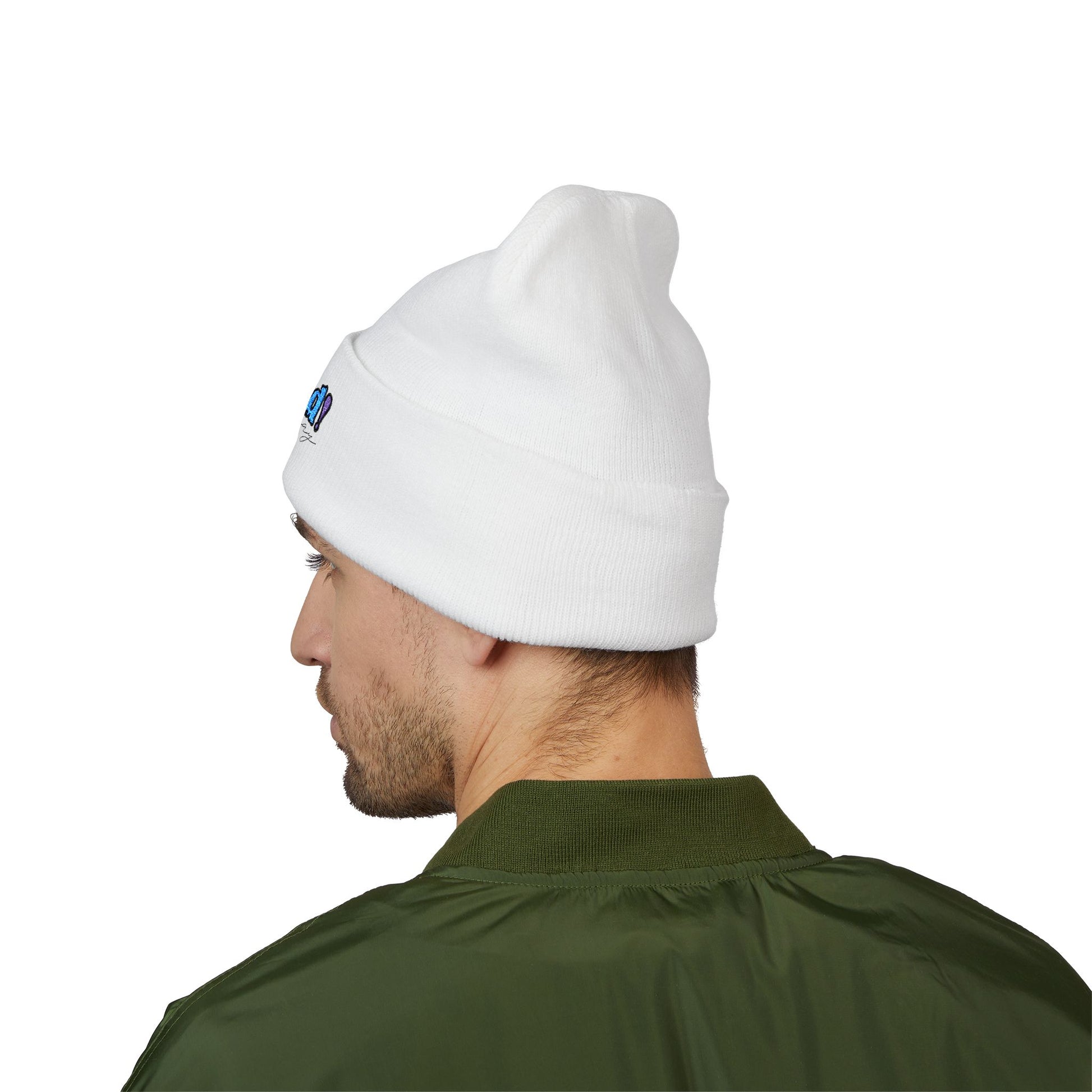 Back view of a person wearing a white beanie with “proud everyday" embroidered in rainbow colors and a green jacket, looking slightly to the side with a neutral expression. Perfect for the LGBTQ community from the Worldwide PRIDE store.
