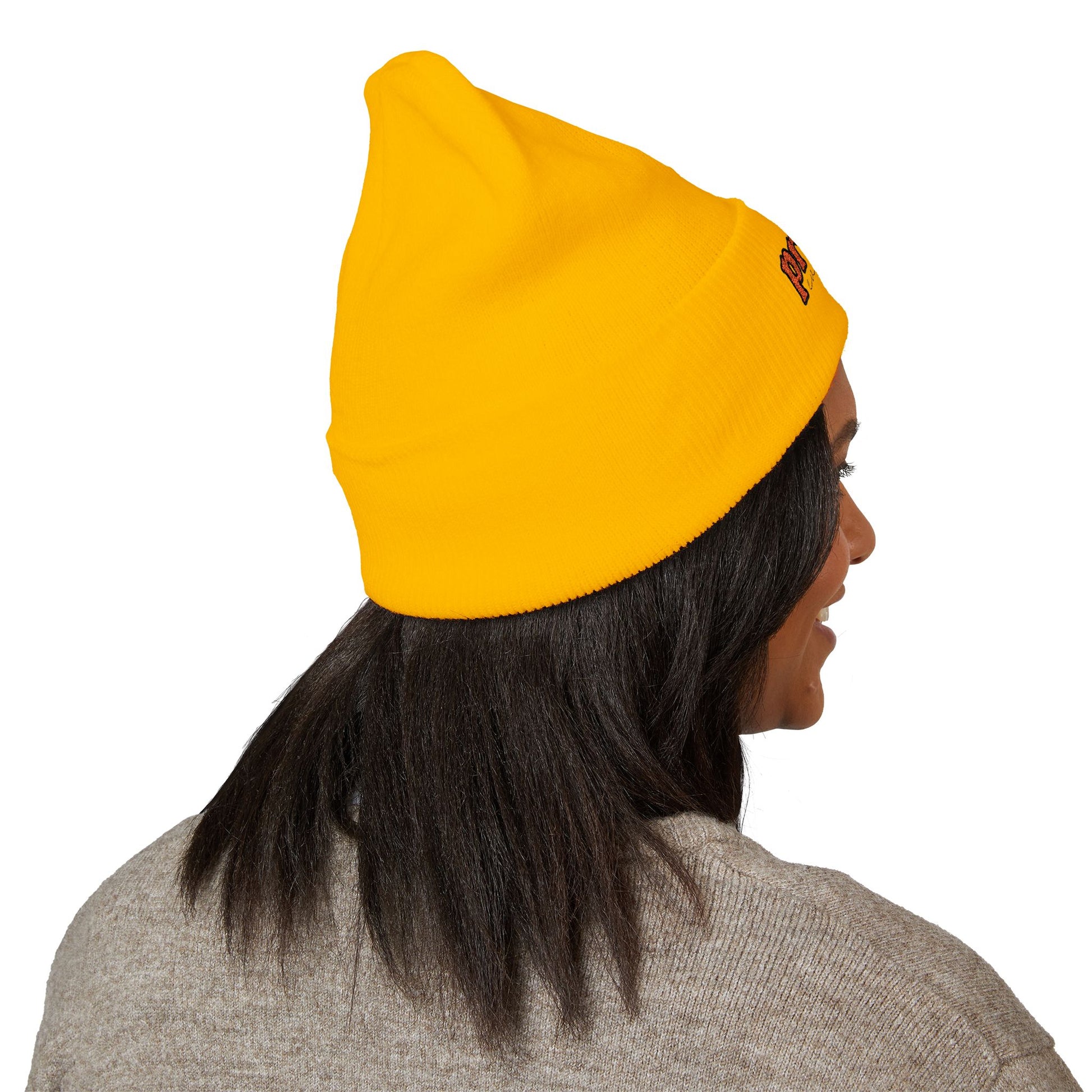 Back view of a person wearing a yellow beanie with “proud everyday" embroidered in rainbow colors and a heather brown sweater, looking slightly to the side with a neutral expression. Perfect for the LGBTQ community from the Worldwide PRIDE store.