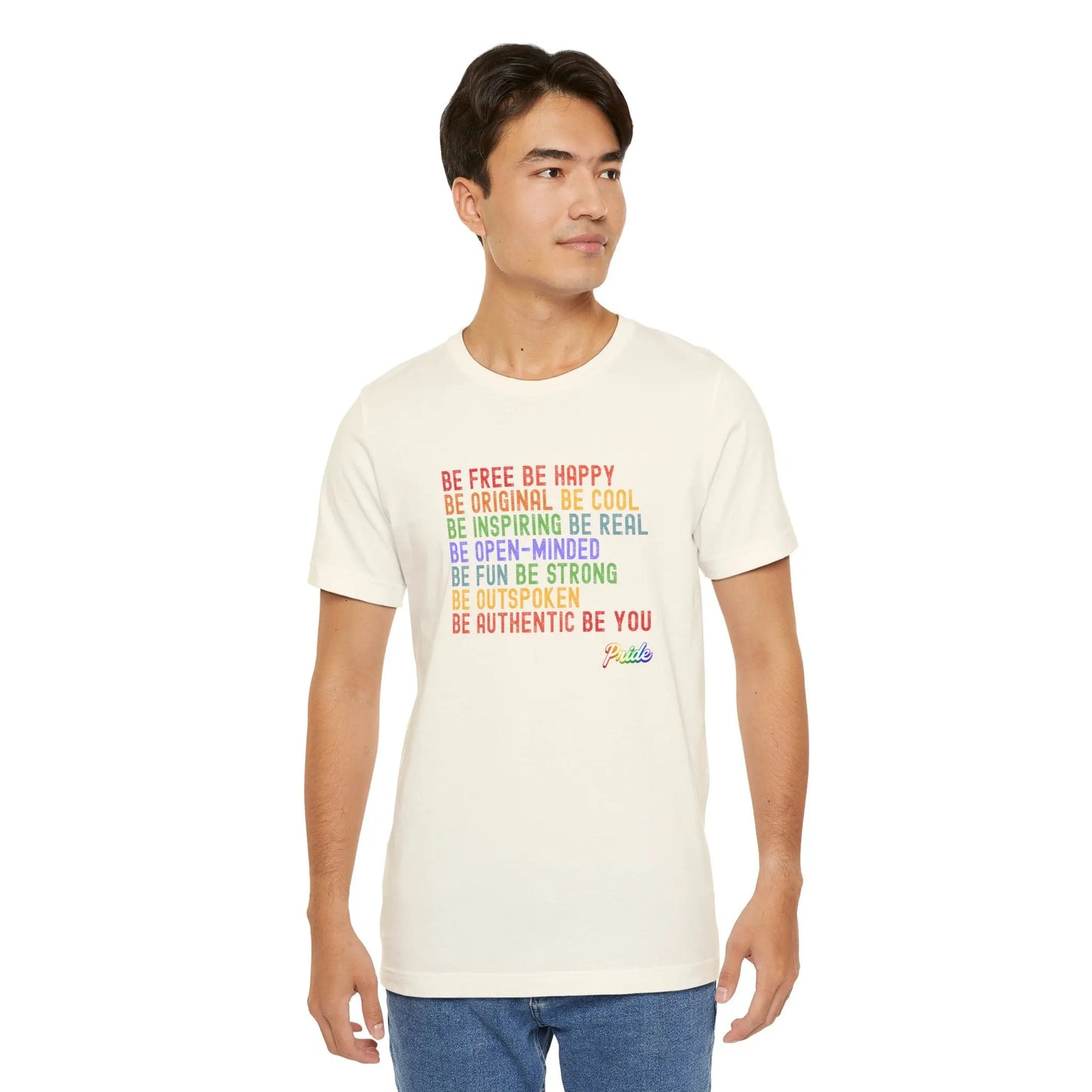 Man wearing the worldwide pride motto beige t-shirt with colorful text on a white background.