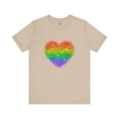 A beige t-shirt with a glitter rainbow heart design.