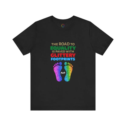 A black unisex short-sleeve t-shirt with a graphic of multicolored glitter footprints and the text 'THE ROAD TO EQUALITY IS LITTERED WITH GLITTERY FOOTPRINTS'.