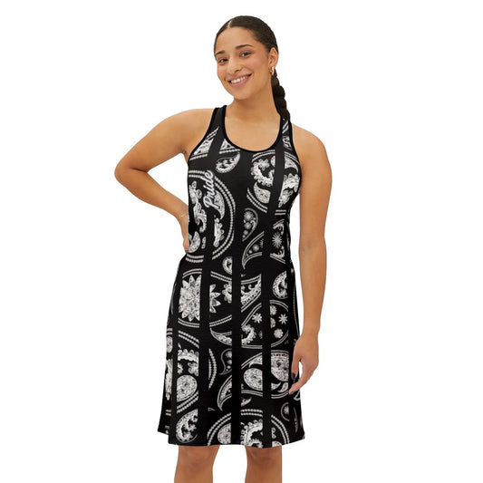 A woman standing and posing in a black and white Worldwide PRIDE racerback dress with a floral pattern.