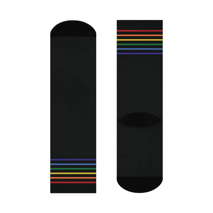 A pair of black crew socks with a colorful striped pattern representing the LGBTQ community.