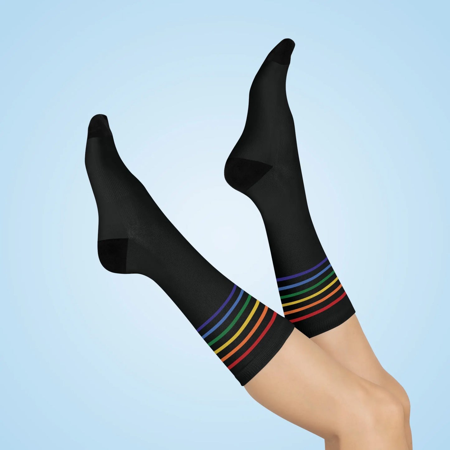A pair of black crew socks with a colorful striped pattern representing the LGBTQ community.