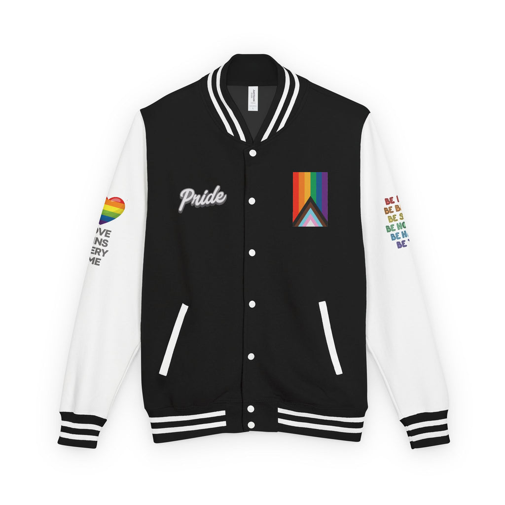 A black and white letterman jacket from the Worldwide PRIDE store, adorned with a rainbow heart above the words "love wins every time" on the right sleeve, and the progress PRIDE flag, and the word PRIDE on the chest. The left sleeve is obstructed but reads: Be kind, be brave, be silly, be honest, be happy, be you.