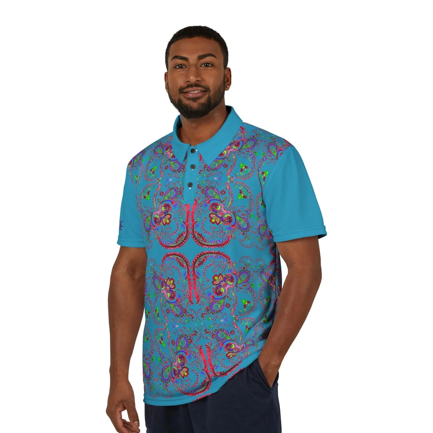 A person wearing a polo shirt with a blue background featuring a red paisley pattern.