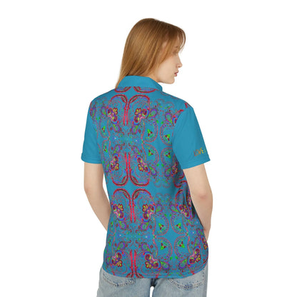 A person wearing a polo shirt with a blue background featuring a red paisley pattern.