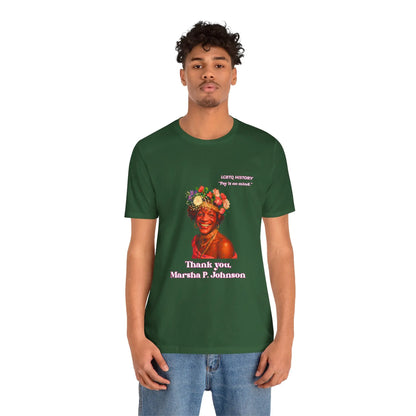 Person wearing a green t-shirt with a Marsha P. Johnson graphic and text on a white background