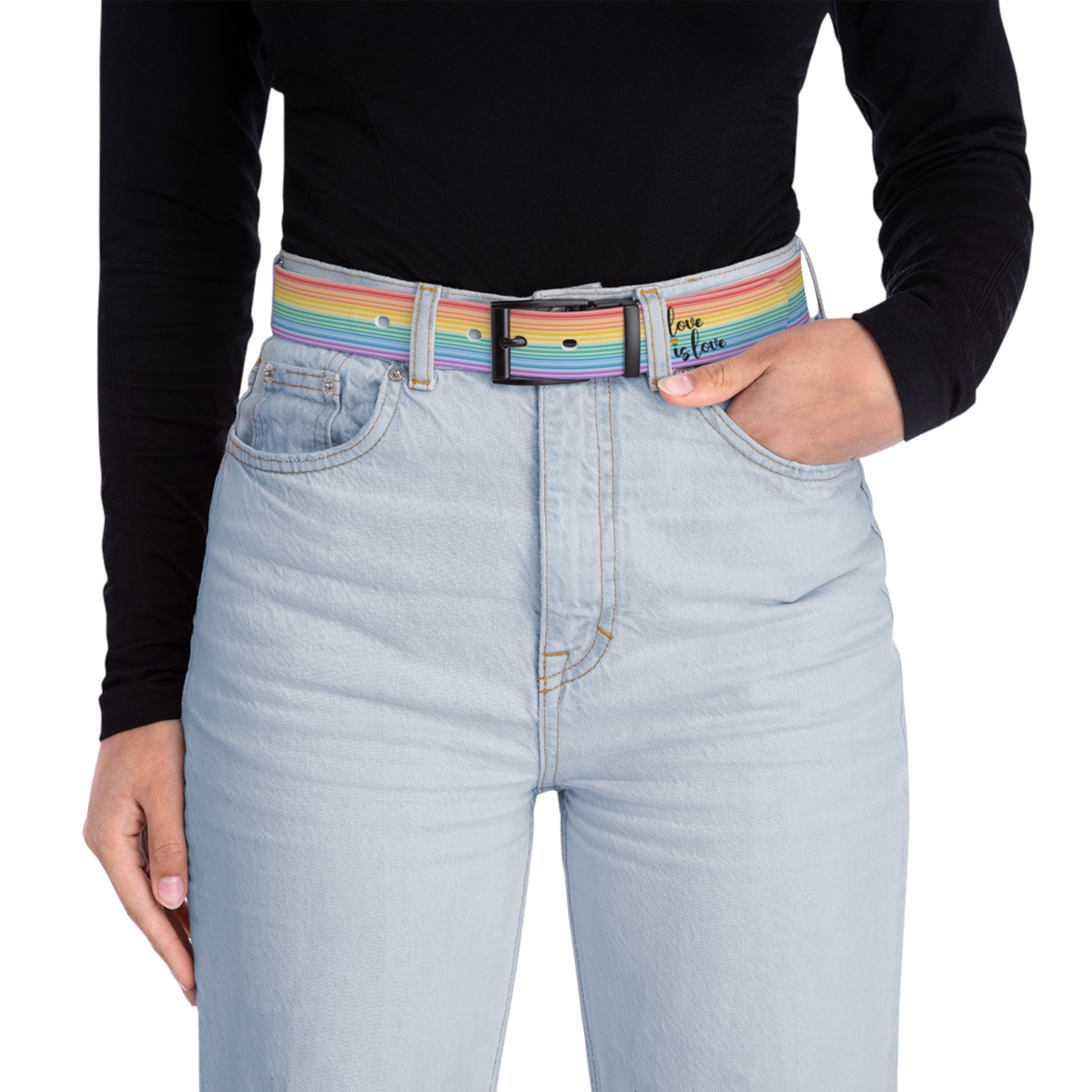 A person wearing a black long-sleeve shirt and light blue jeans with the Worldwide PRIDE rainbow-striped Love is Love belt with black buckle, showing support for the LGBTQ+ community, with one hand in their pocket.