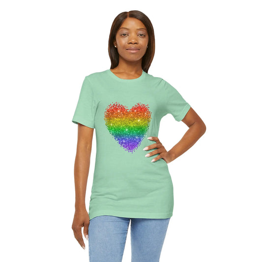 A person wearing a mint green t-shirt with a glitter rainbow heart design.