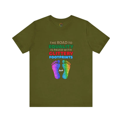 An olive green unisex short-sleeve t-shirt with a graphic of multicolored glitter footprints and the text 'THE ROAD TO EQUALITY IS LITTERED WITH GLITTERY FOOTPRINTS'.