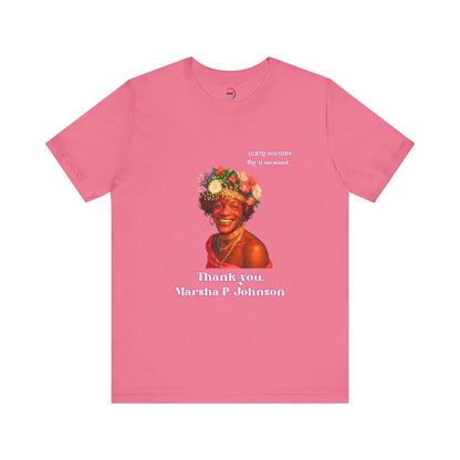 Pink t-shirt with a graphic of Marsha P. Johnson with flowers in her hair and text on a white background