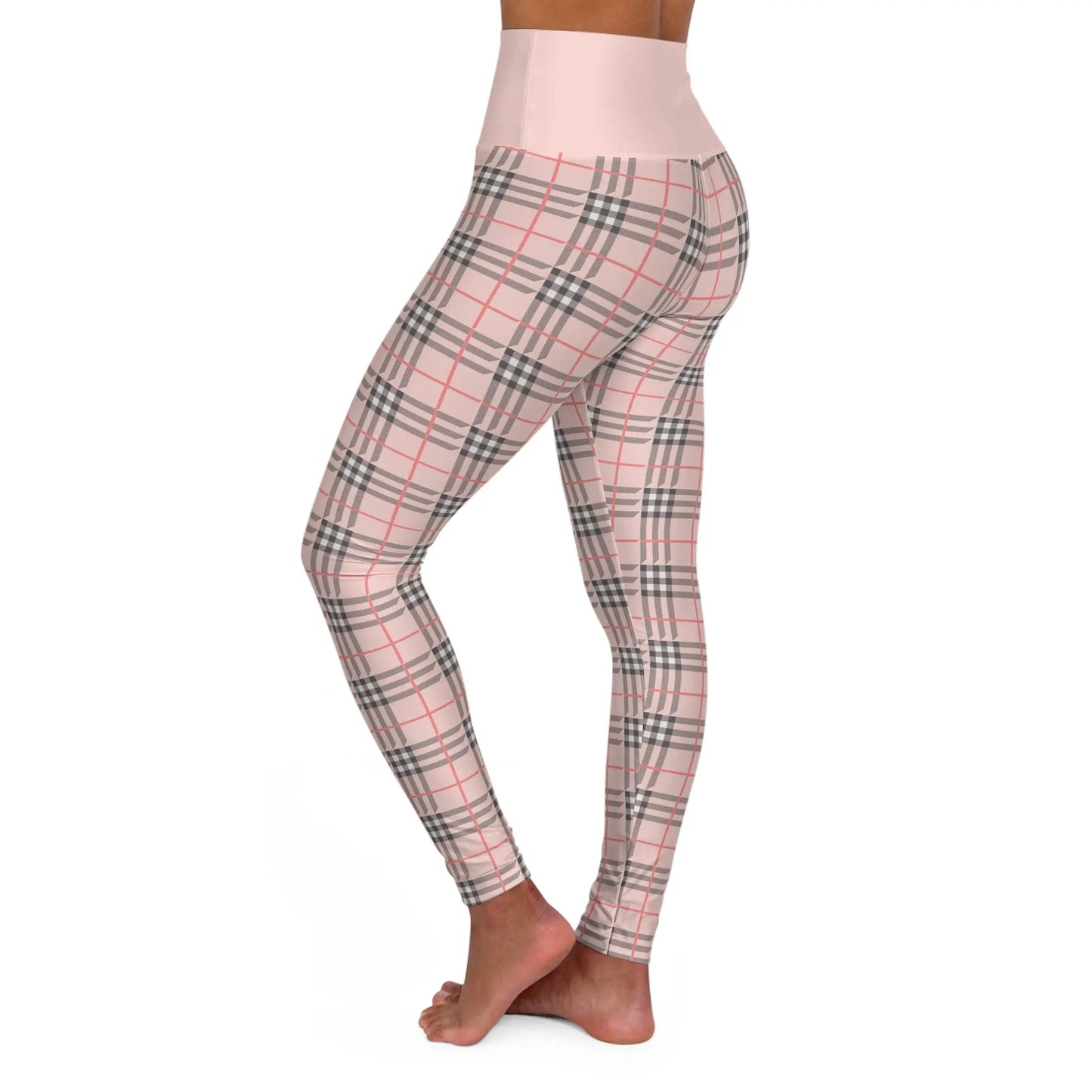 Side view of a person wearing a pair of high waisted yoga leggings with a plaid pattern.