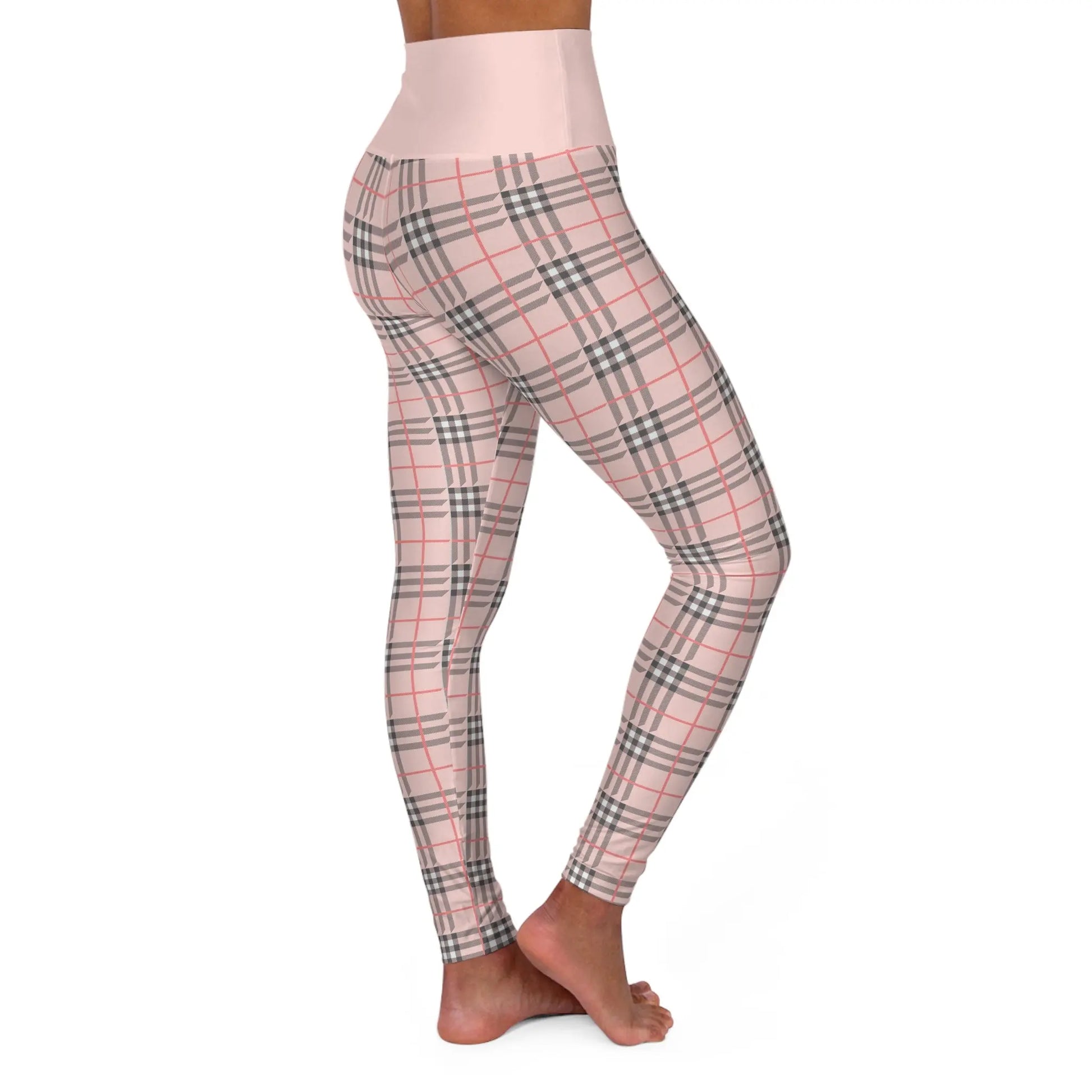 Side view of a person wearing a pair of high waisted yoga leggings with a plaid pattern.