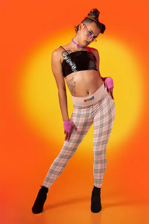 A person wearing a pair of high waisted yoga leggings with a plaid pattern and a visible brand logo that reads "proud everyday" on the waistband.